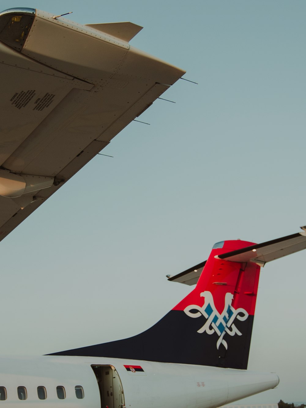 the tail end of an airplane as it sits on the tarmac