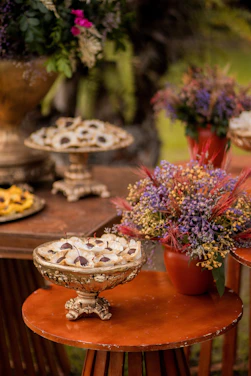 A beautifully decorated pastel with vibrant colors and intricate designs on a rustic wooden table.