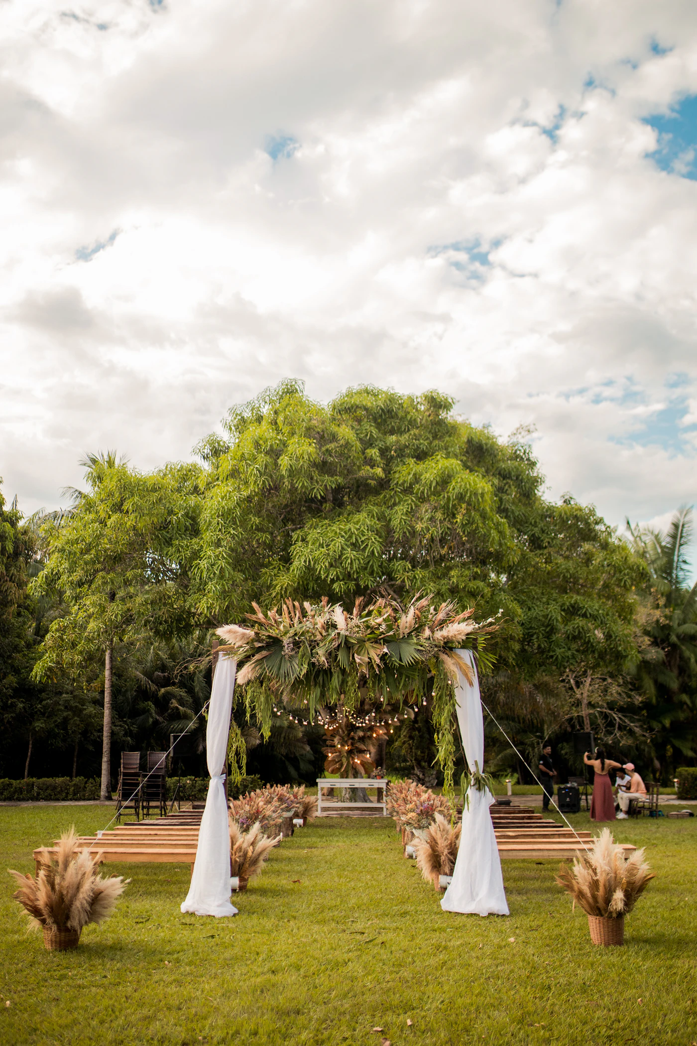 Permits for public park weddings in major U.S. cities — A couple exchanges vows under a floral arch in a public park.