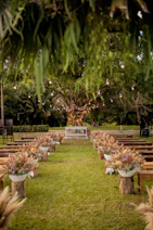 rows of wooden benches sitting on top of a lush green field