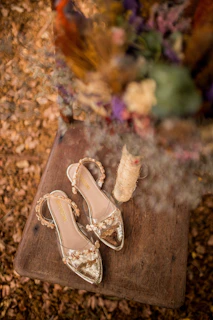 Close-up of colorful crochet sandals on a sunlit tropical wooden deck