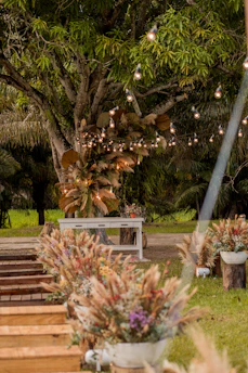Elegant plant arrangements decorating a rustic wedding venue with natural light.