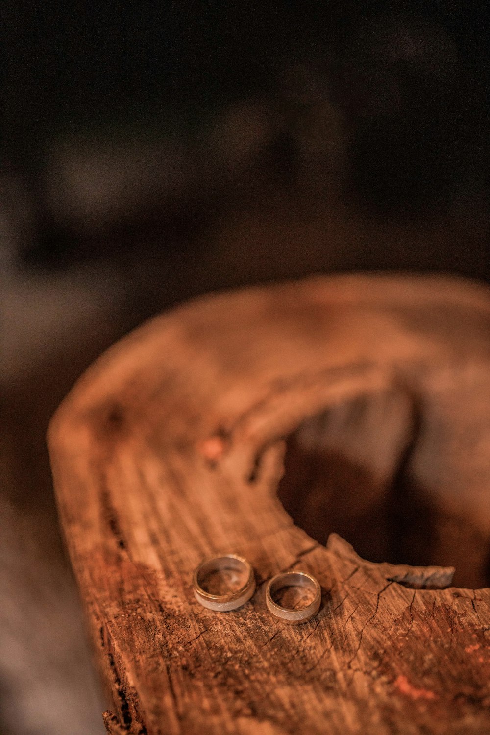 a close up of a pair of scissors on a piece of wood