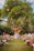 A lively outdoor wedding reception with a musician playing under string lights.