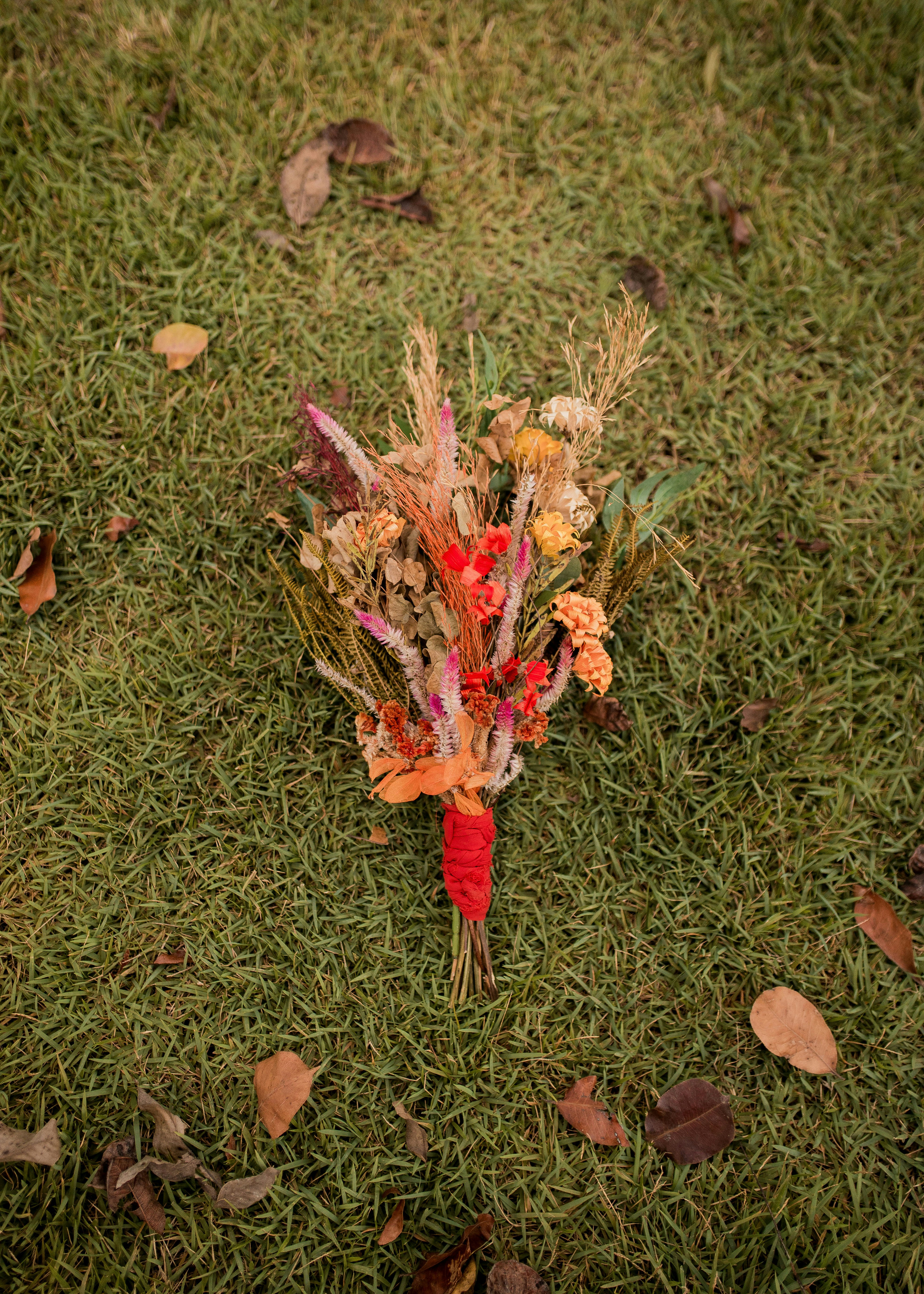 a bouquet of flowers on the ground in the grass