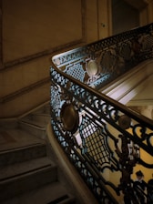 Elegant wrought iron stair railing with intricate floral patterns in a cozy home setting.
