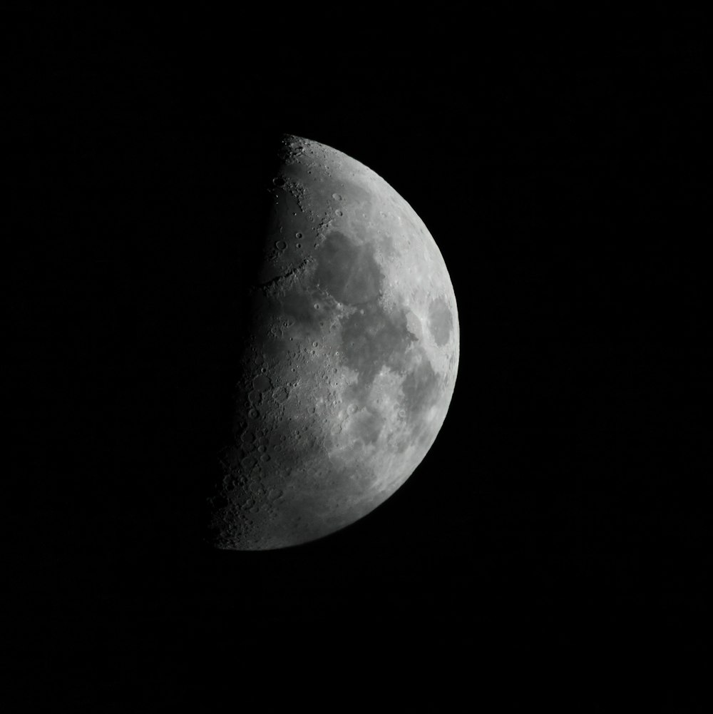 a half moon is shown in the dark sky