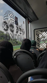 Passengers using free wifi on their devices inside a moving bus.