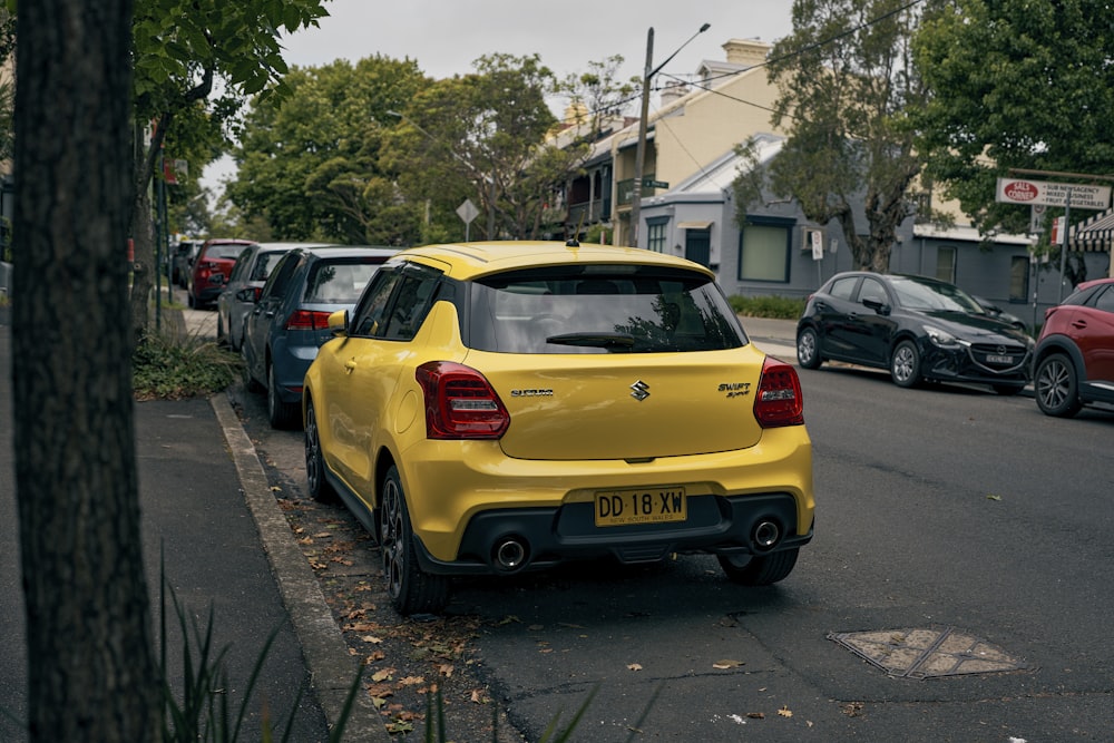 a yellow car parked on the side of the road
