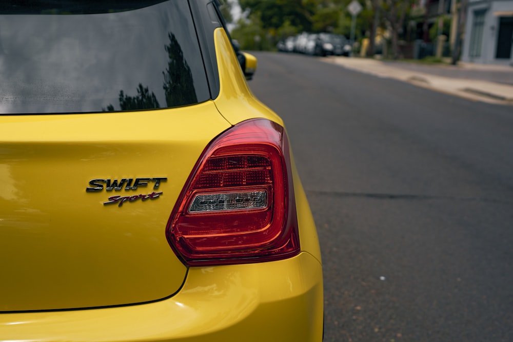 a yellow car parked on the side of the road