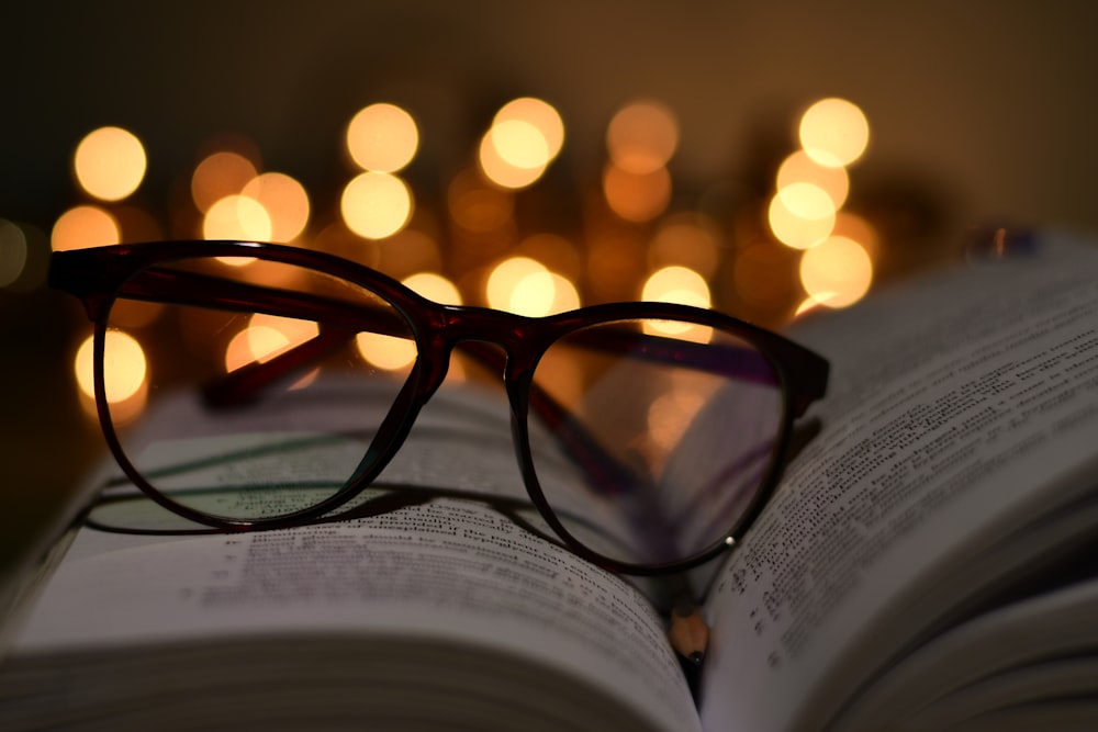 a pair of glasses resting on an open book