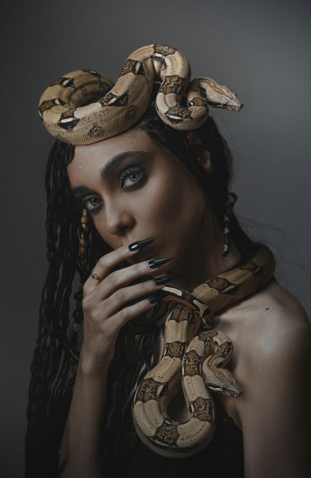 a woman with a snake on her head