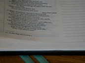 Close-up of an open Bible with a red, white, and blue bookmark