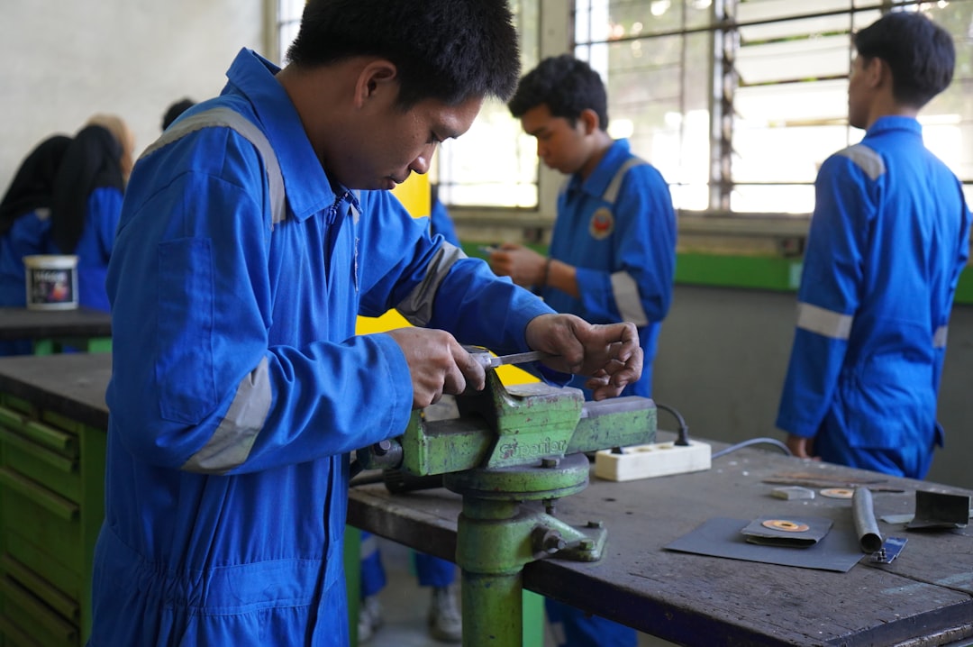 a group of men working on a piece of metal,