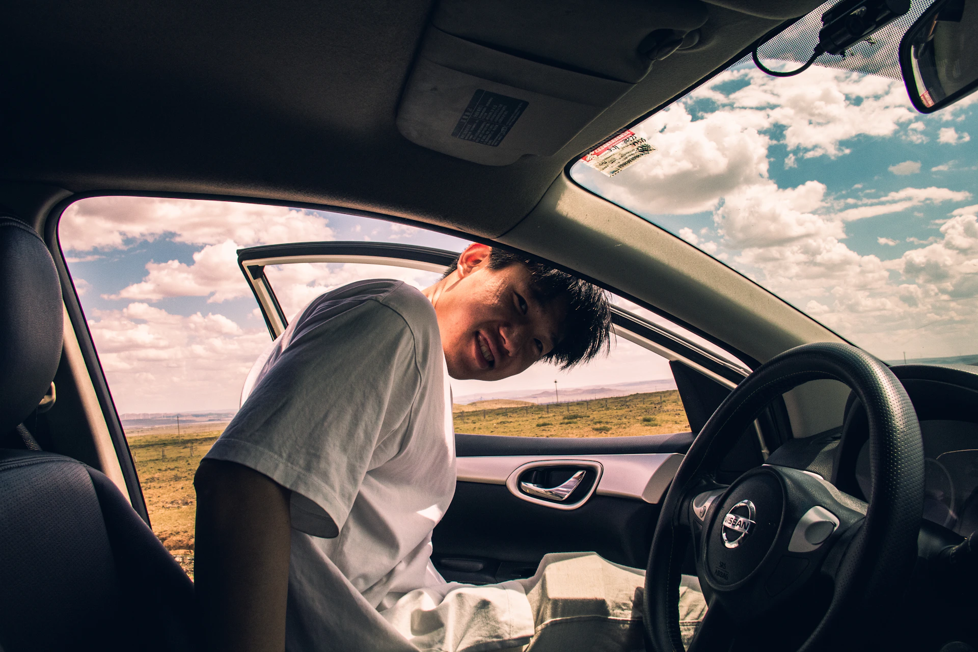 a man sitting in the driver's seat of a car