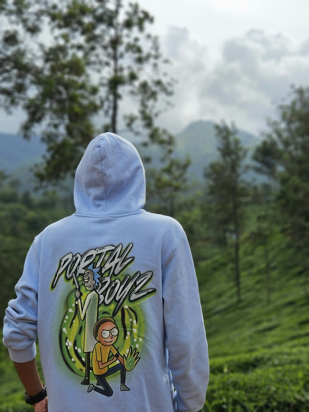 a person wearing a blue hoodie with a cartoon on it
