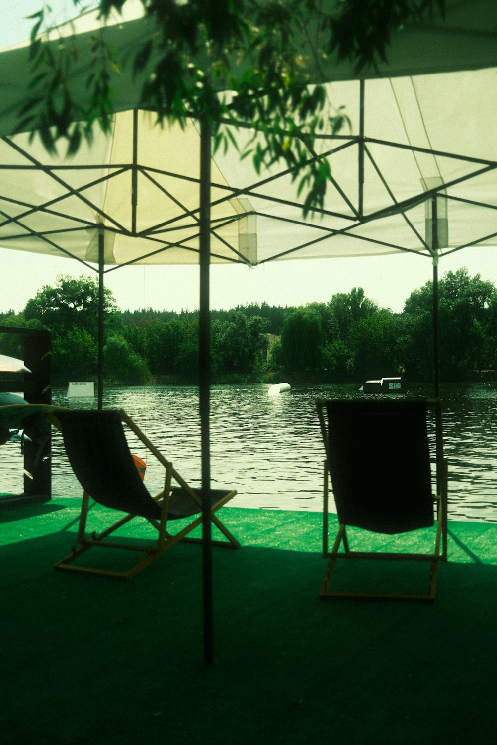 a couple of lawn chairs sitting under an umbrella