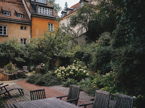 A serene garden with lush greenery and historical architecture.