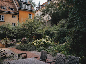 A peaceful garden area adjacent to thermal baths with blooming flowers