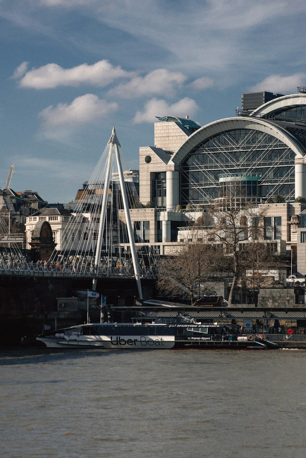 a bridge over a body of water next to a large building