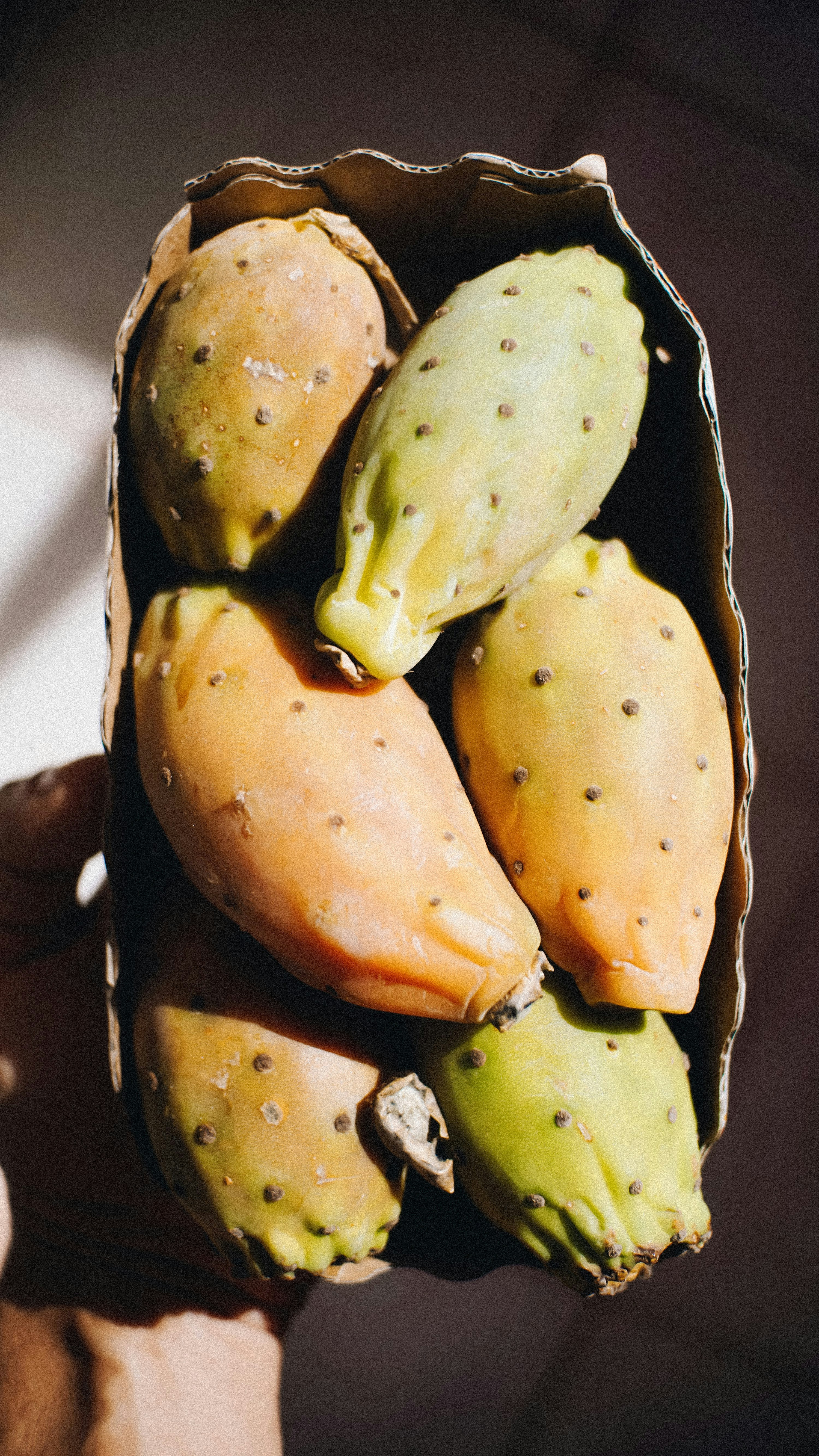 a person holding a bunch of fruit in their hand