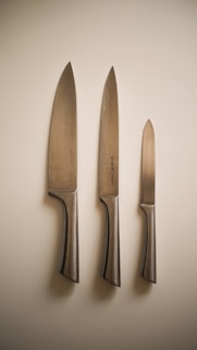 a couple of knives and a knife on a wall