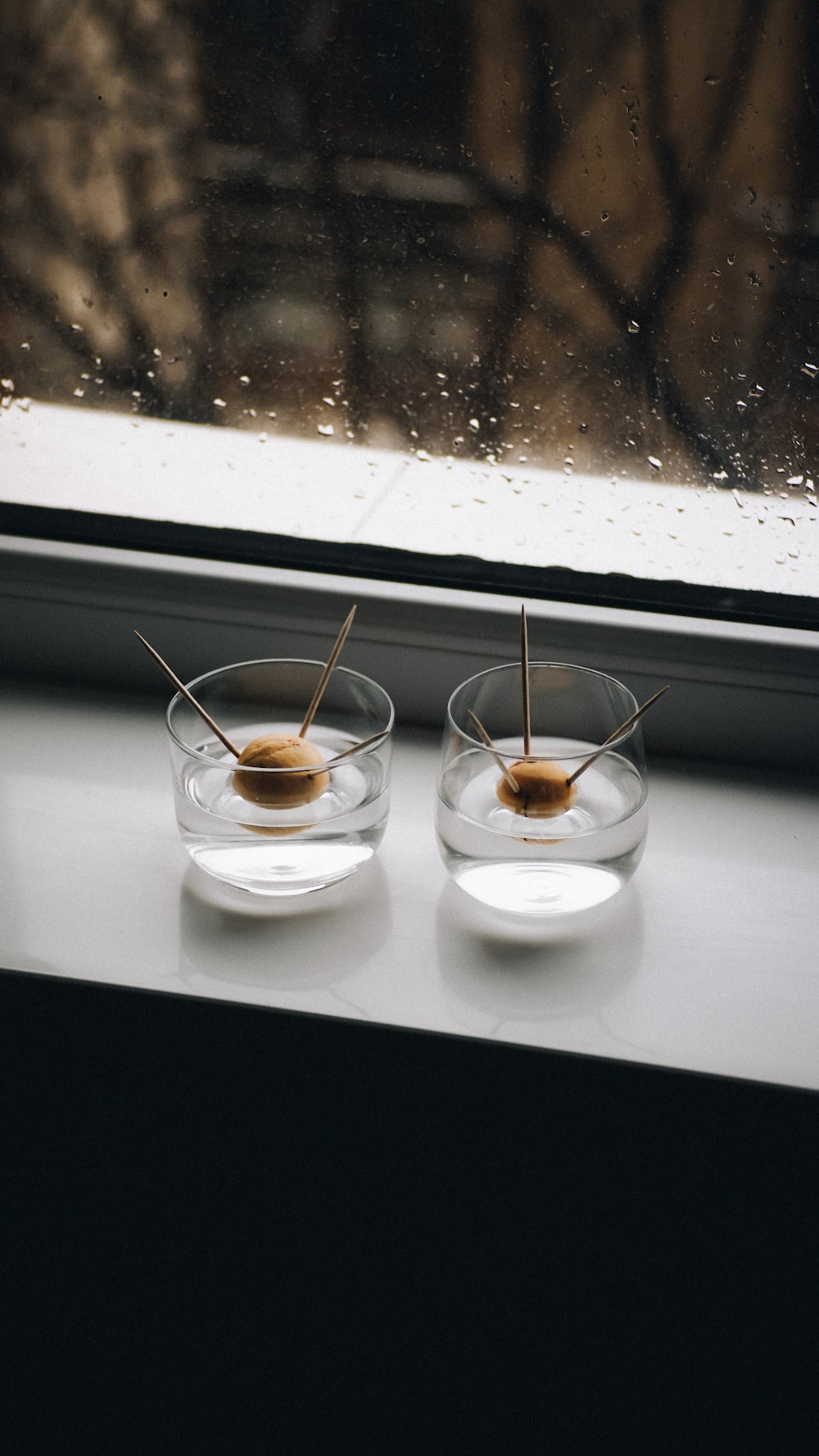 a couple of small bowls sitting on top of a window sill