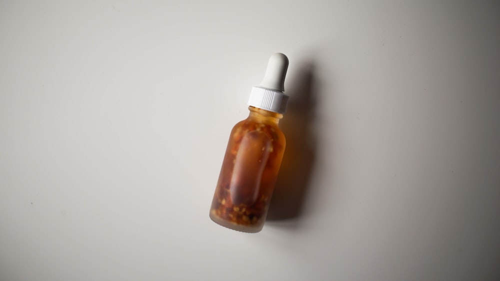 a small bottle of liquid sitting on top of a table