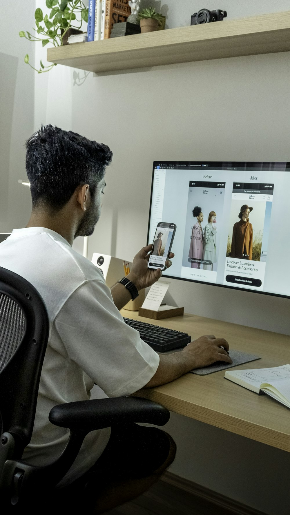 a man sitting at a desk using a computer