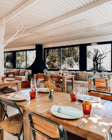Cozy restaurant interior with wooden tables and plates of steaming biryani.