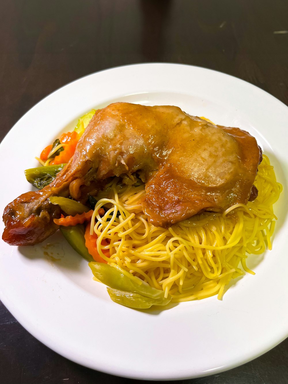 a white plate topped with spaghetti and meat