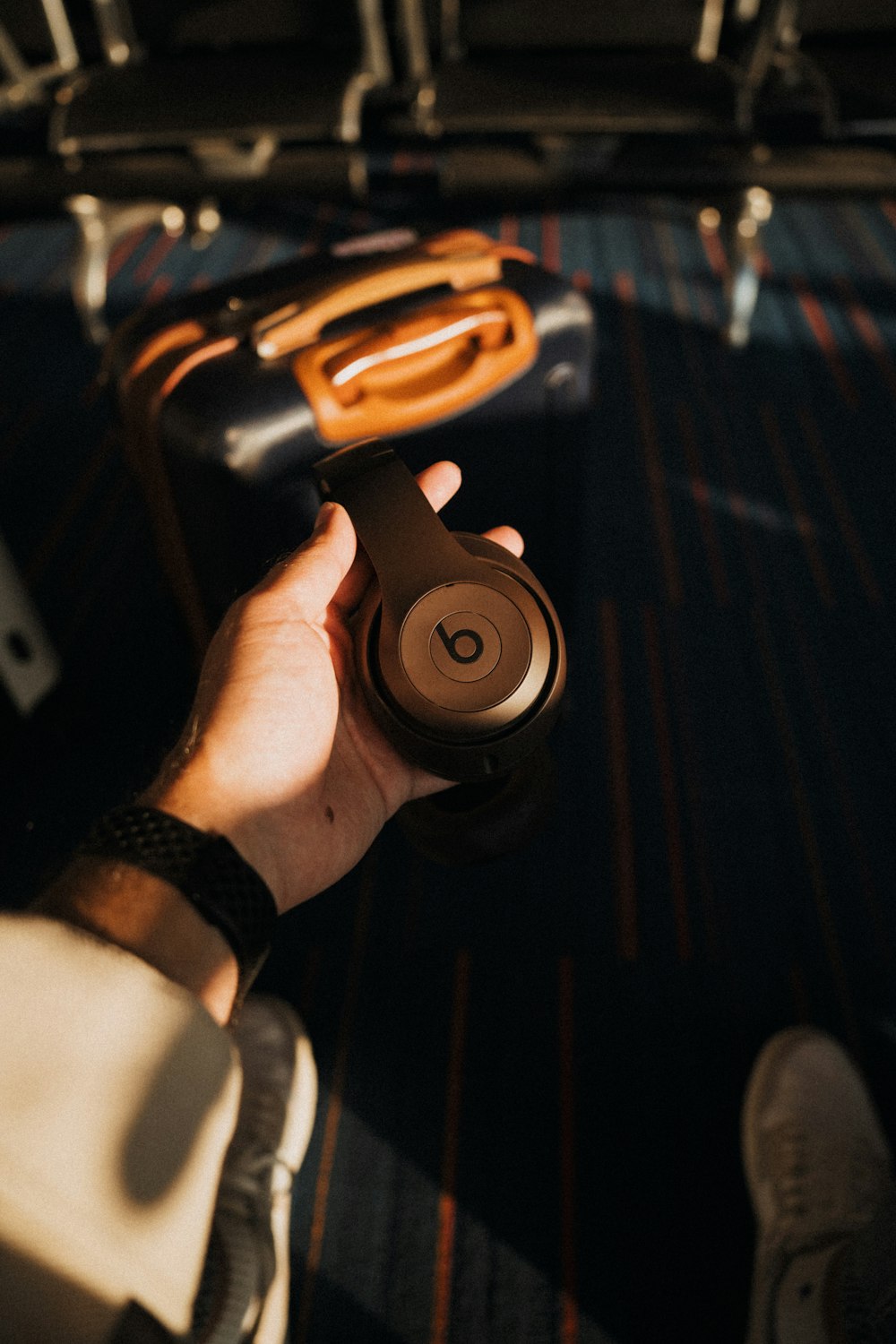 a person holding a pair of headphones in their hand