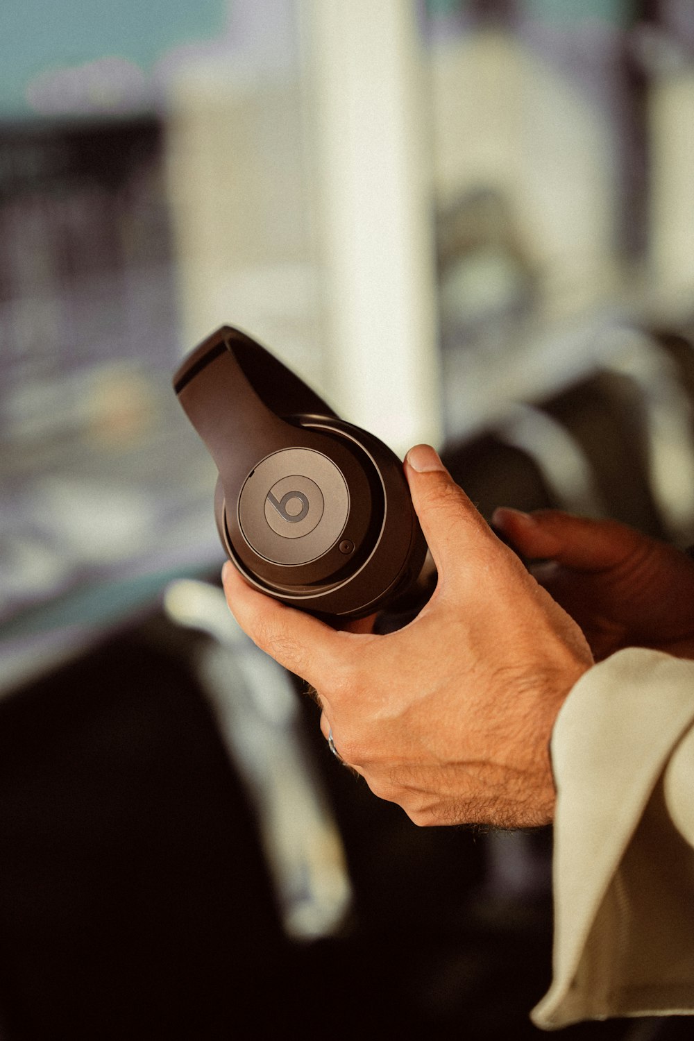 a man is holding a pair of headphones in his hand