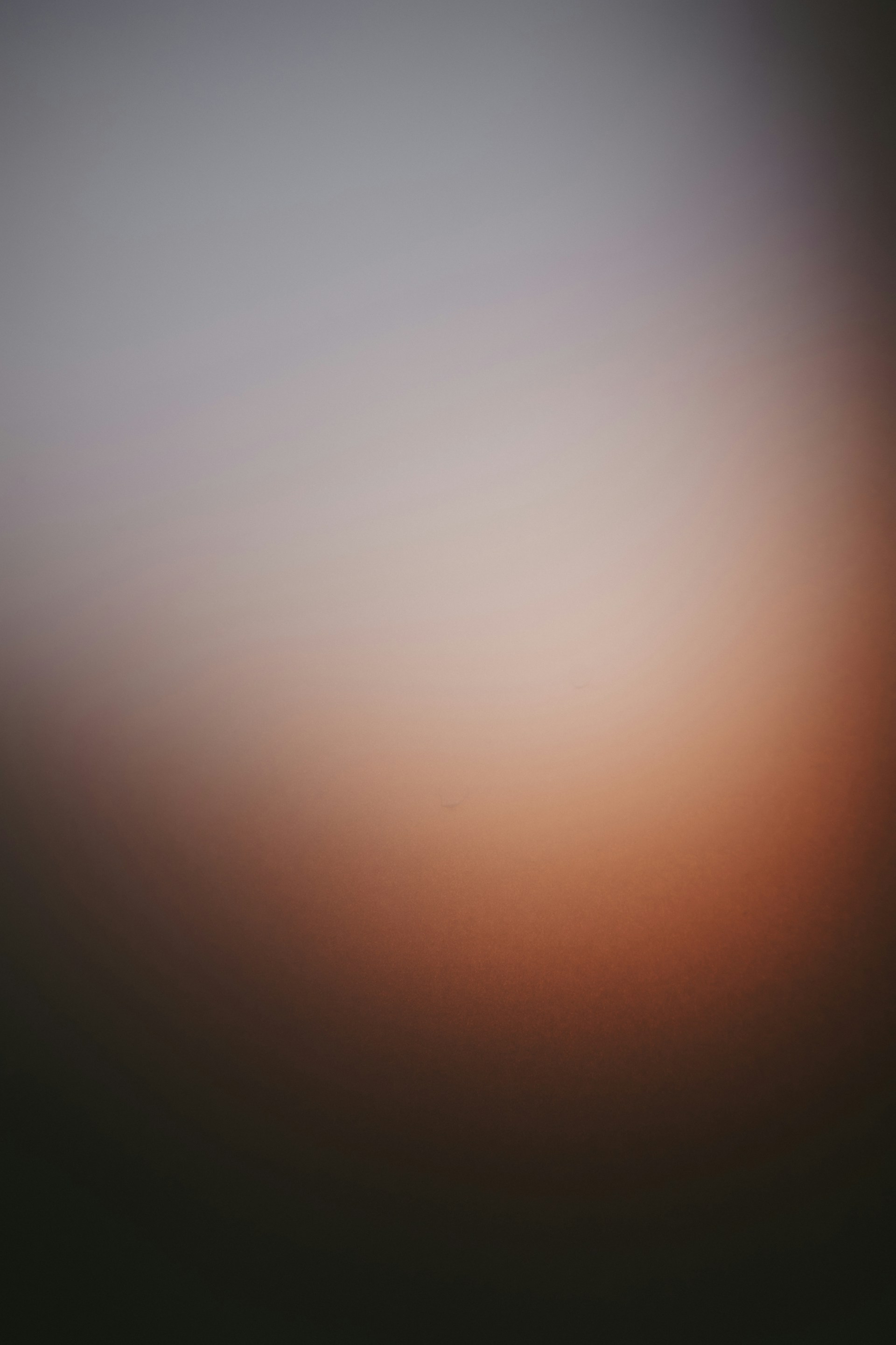 a blurry photo of a black and orange sky