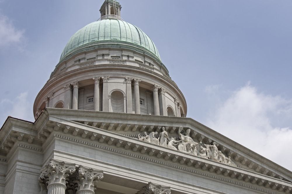 the dome of a building with statues on it