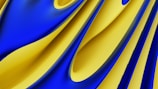 Curved, overlapping fabric-like surfaces in vivid blue and yellow form flowing, abstract shapes. The colors intertwine and blend seamlessly, evoking a sense of motion and fluidity.