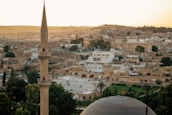 A Moroccan cityscape blending traditional and modern architecture at sunset.