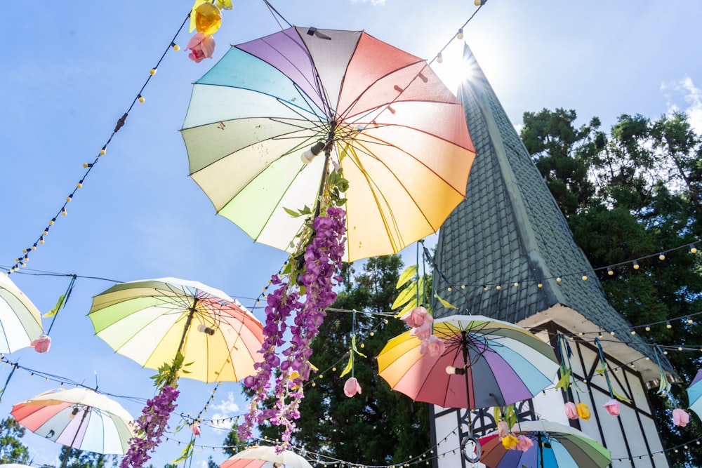 a bunch of umbrellas that are hanging in the air