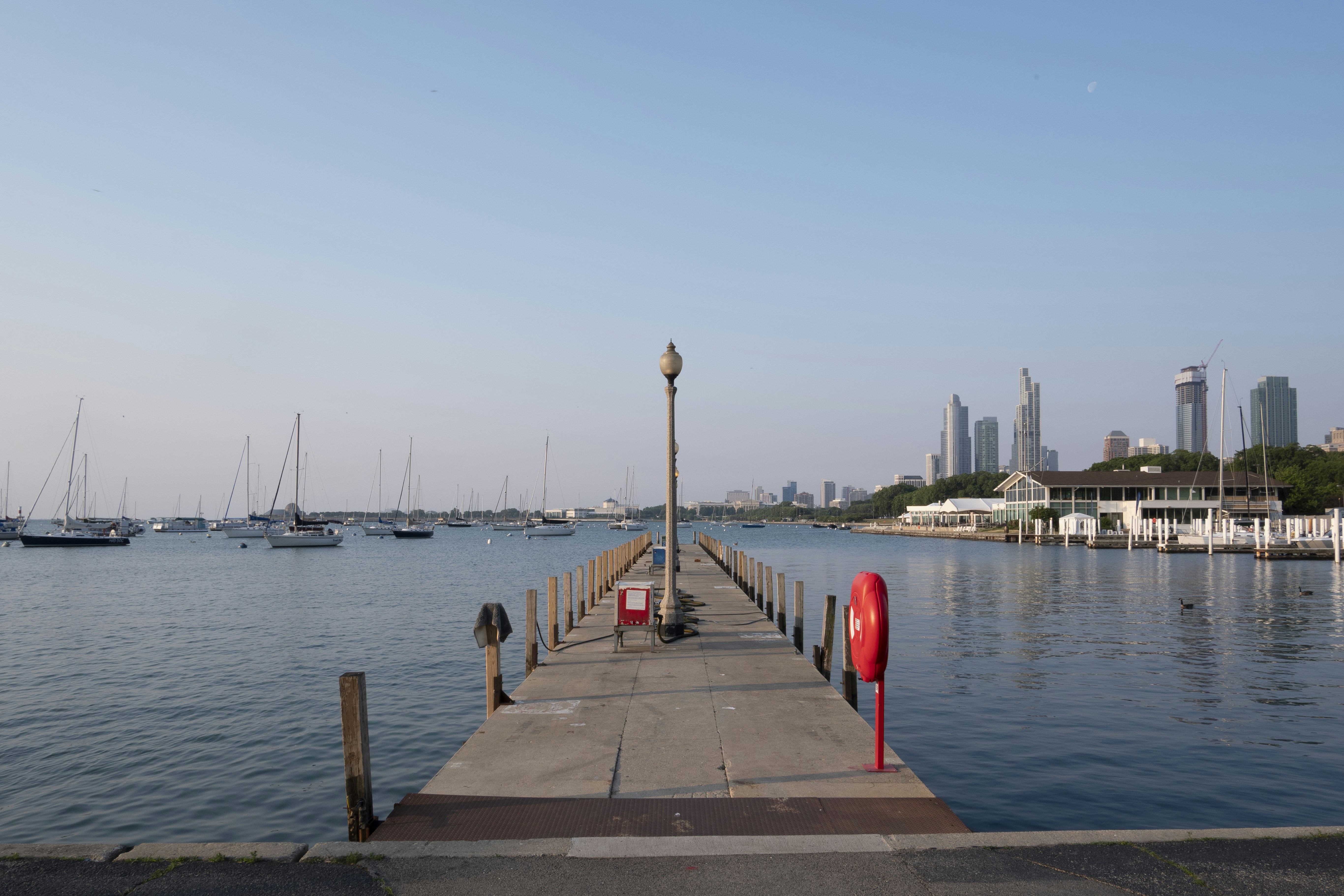 a dock with a few boats in the water, 
