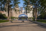 a large metal object sitting in the middle of a park