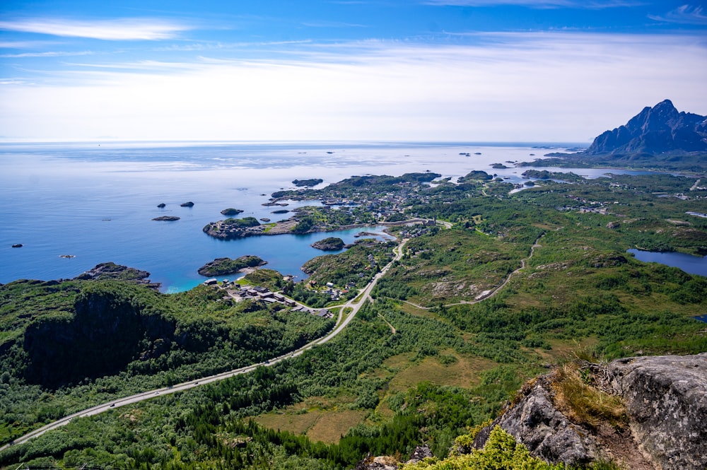 an aerial view of a road and a body of water