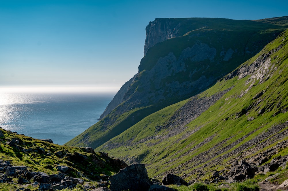 a view of the ocean from the side of a mountain