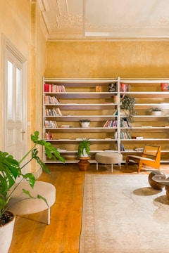 A cozy living room built-in bookshelf made from fine wood with detailed moldings.