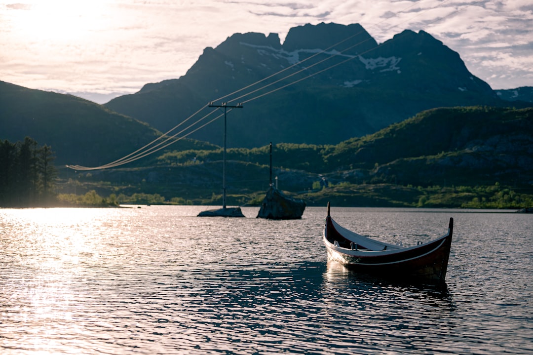 a small boat floating on top of a lake,