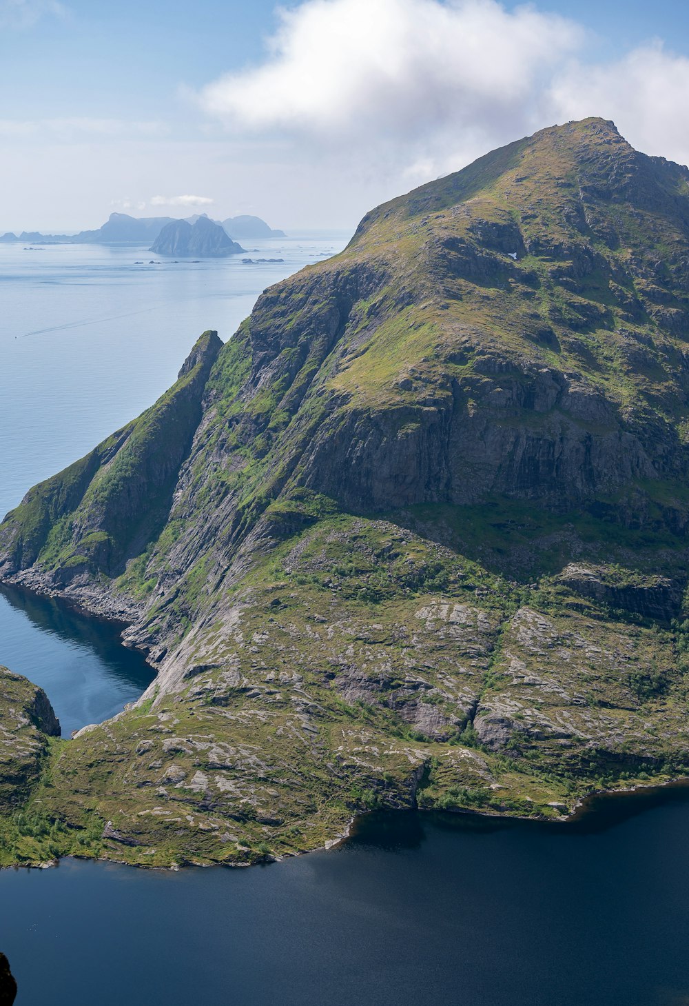 a large mountain with a body of water in the middle of it