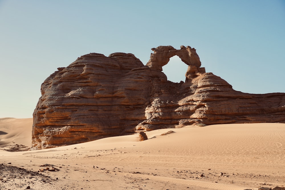 a large rock formation in the middle of a desert