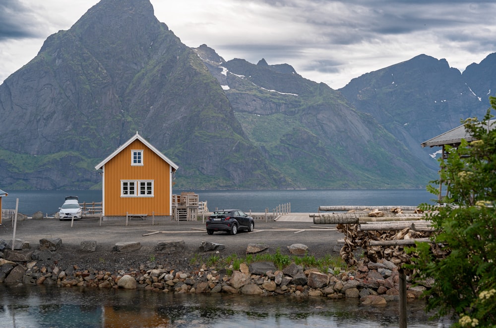 a yellow house sitting next to a body of water