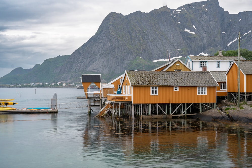 a group of houses sitting on top of a body of water