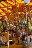 A vibrant carousel with colorful horses at the amusement park.