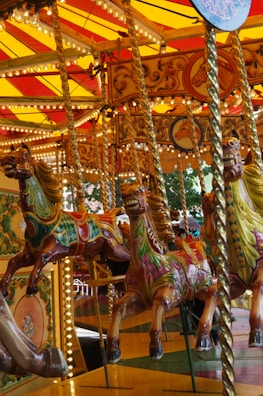 A vibrant carousel with colorful horses at the amusement park.